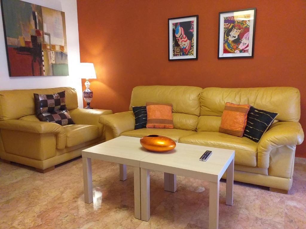 a living room with a couch and a table at Arrecife de las Sirenas in Almería