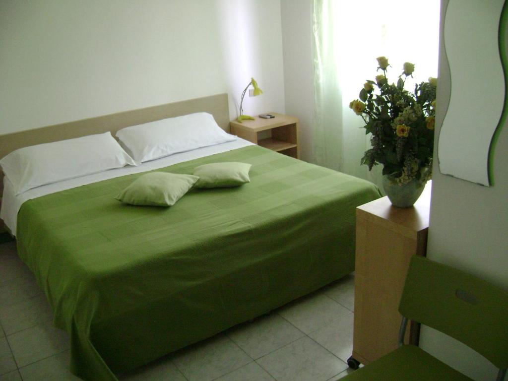 Postel nebo postele na pokoji v ubytování Albergo Moderno