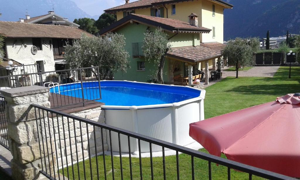 een groot zwembad in een tuin naast een huis bij CasaVarone in Riva del Garda
