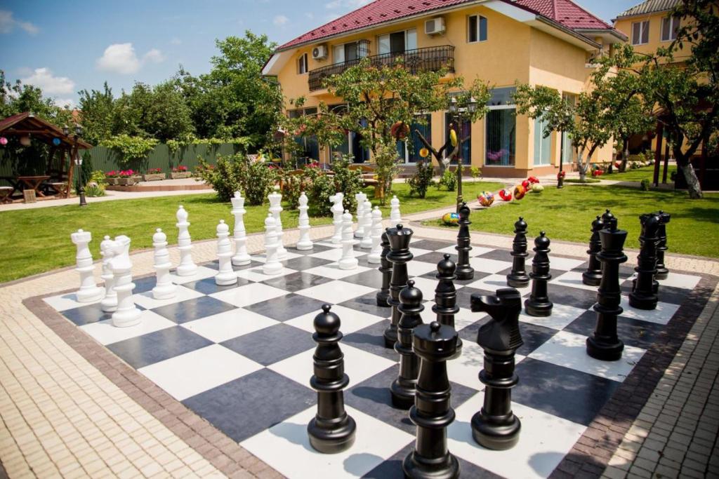 a chessboard on a sidewalk in front of a house at Beauty Complex in Berehove