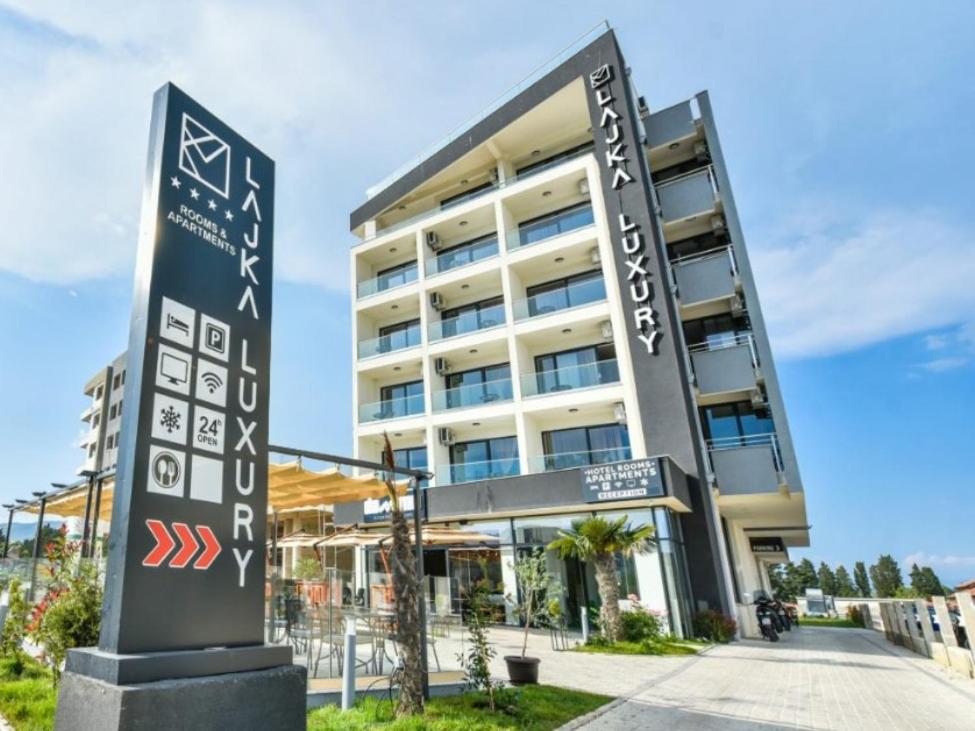 a building with a sign in front of it at Hotel Lajka Luxury in Ulcinj