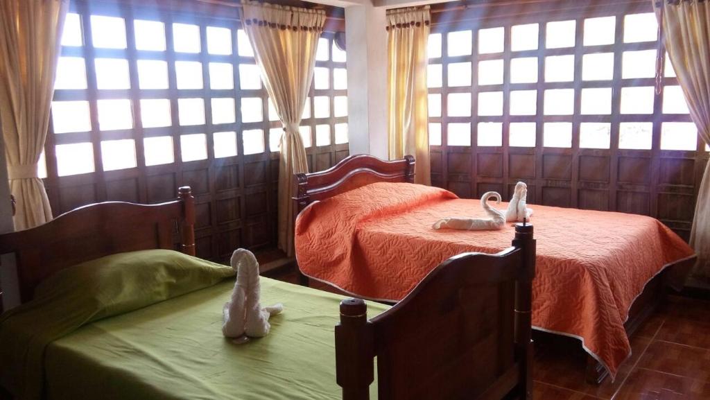 Postel nebo postele na pokoji v ubytování Chez Alicia Hostal