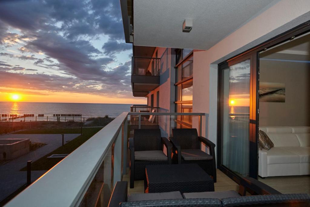 a balcony with chairs and a view of the ocean at Gardenia Sea Side MARTINA 1 Dziwnów in Dziwnów