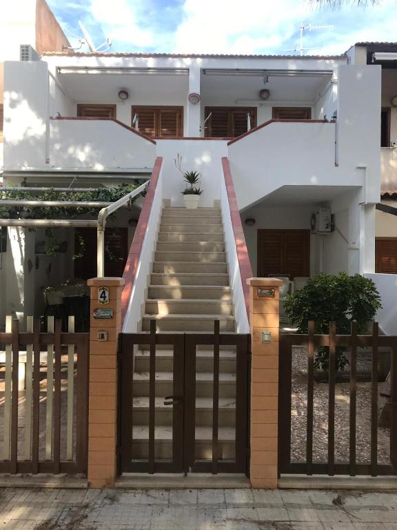 a house with a gate and stairs in front at Casa Vacanze Ciullo d'Alcamo in San Vito lo Capo