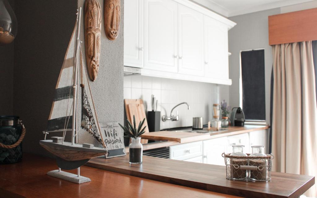 a kitchen with a sail boat on a counter at Lovely oceanview beach house in Portimão