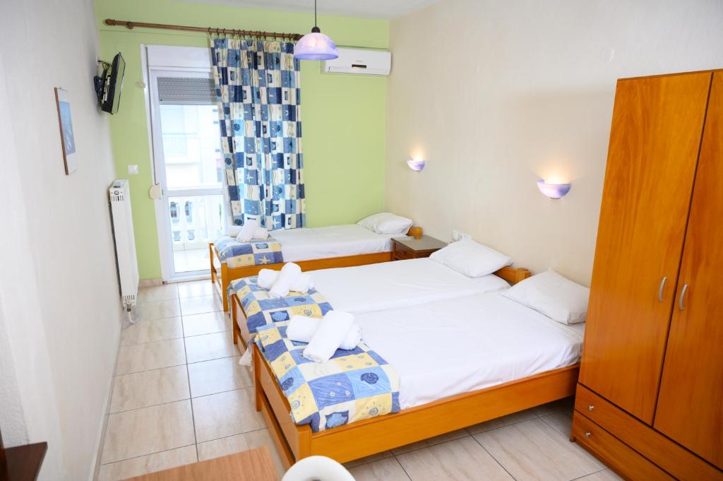Postel nebo postele na pokoji v ubytování GLIKERIA ROOMS