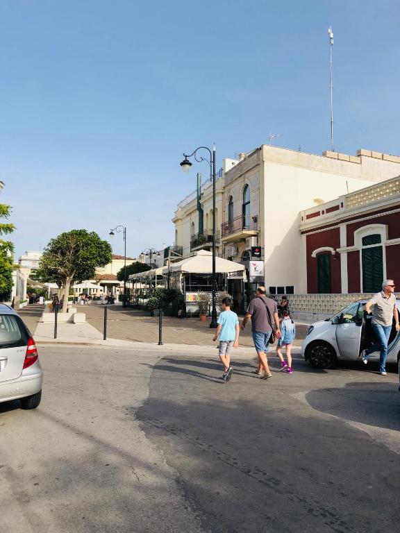 a group of people walking across a street at Relax House in Bari