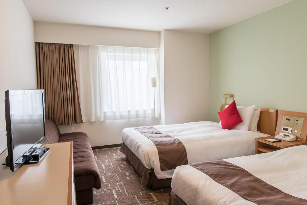 Postel nebo postele na pokoji v ubytování IP City Hotel Osaka - Imperial Palace Group