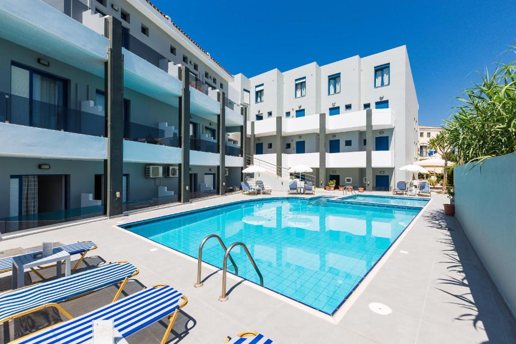 a swimming pool in front of a building at Yacinthos in Rethymno Town