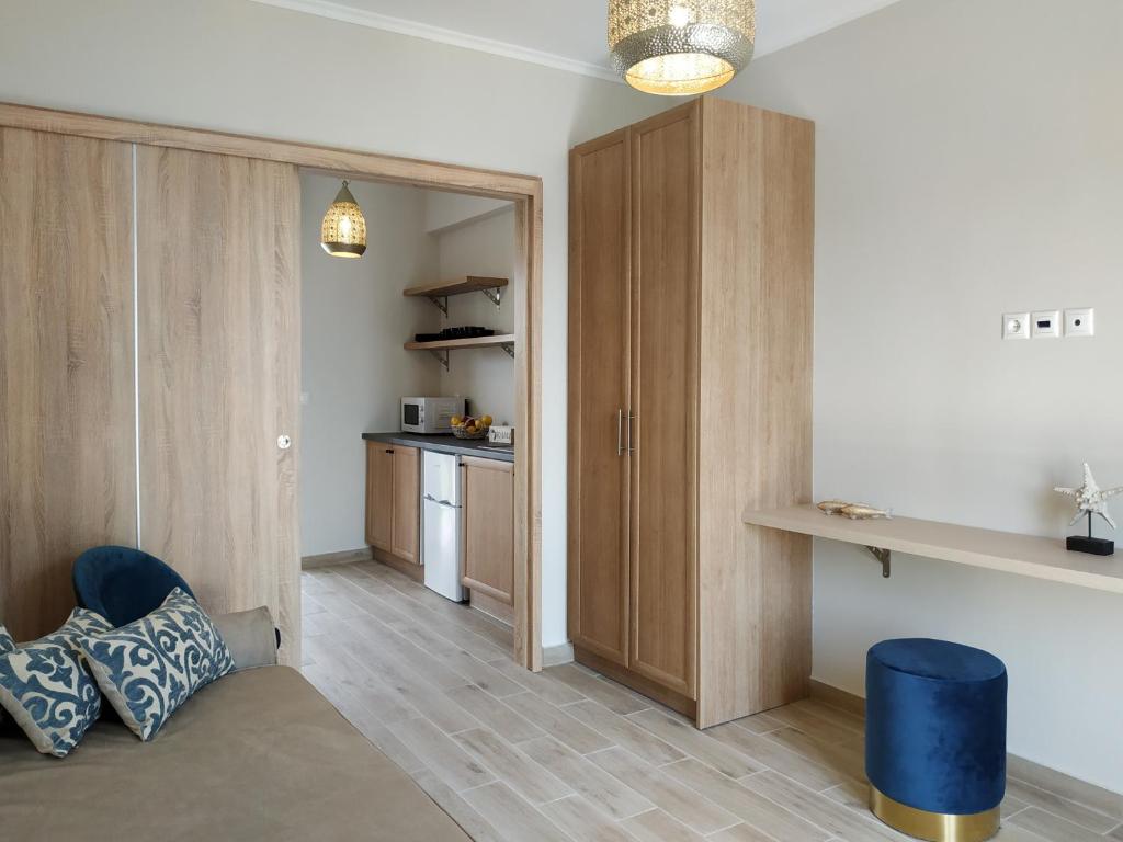 a living room with wooden cabinets and a kitchen at Lilly Apartments in Athens