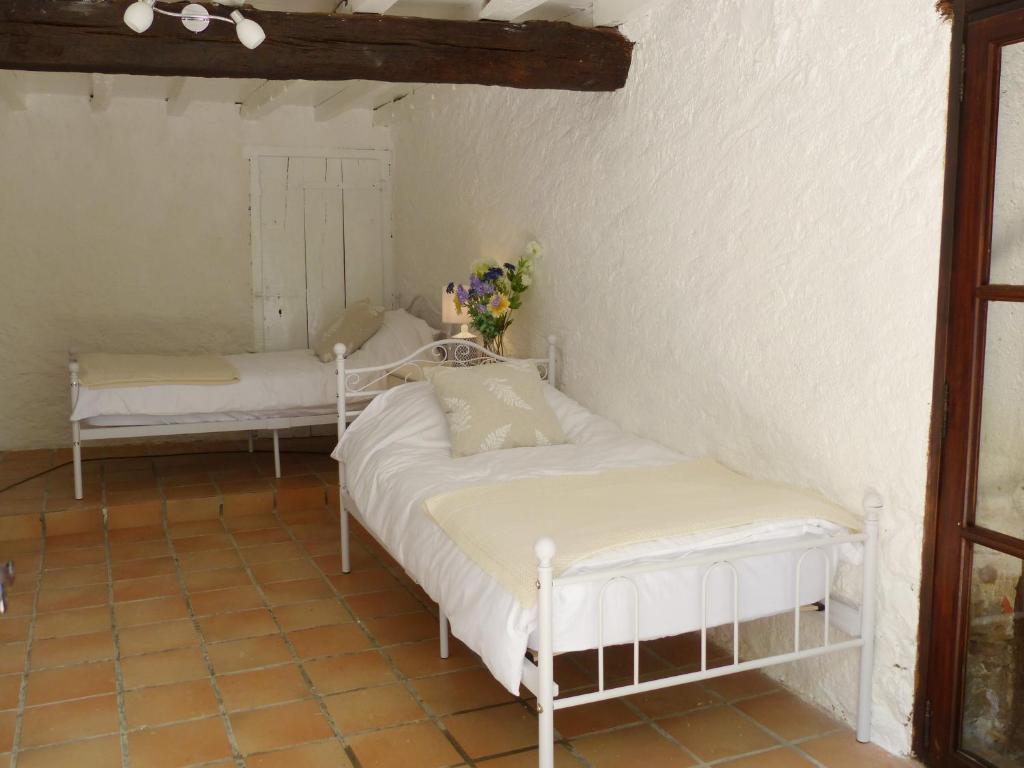 a bedroom with two beds in a room at Hameau de Montcabirol - Foix in Mirepoix