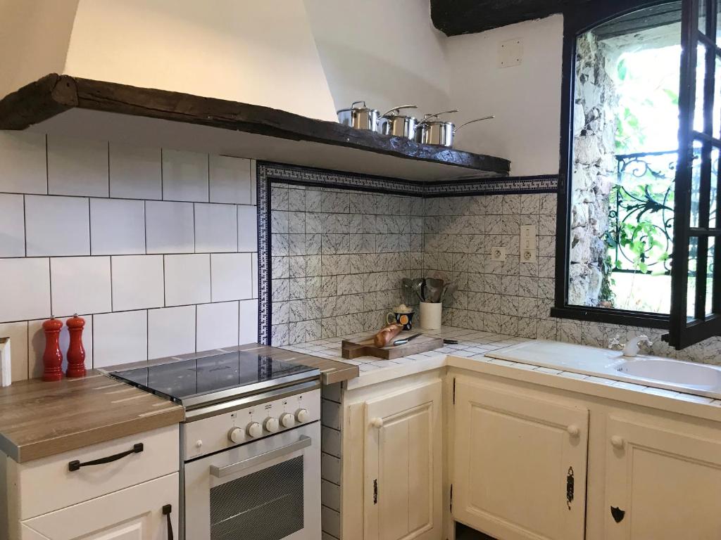 a kitchen with a sink and a stove top oven at Hameau de Montcabirol - Foix in Mirepoix