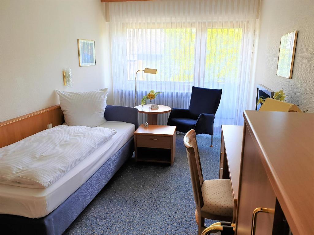 Postel nebo postele na pokoji v ubytování Hotel Rheinland