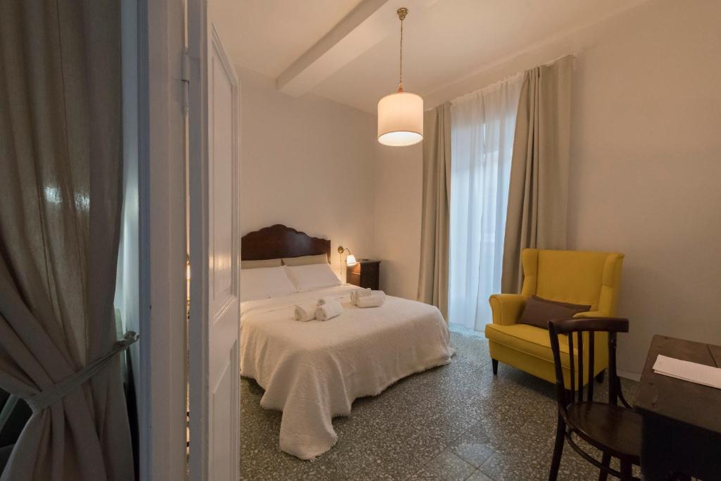 Un dormitorio con una cama y una silla amarilla. en Montecavallo Apartment, en Ronciglione