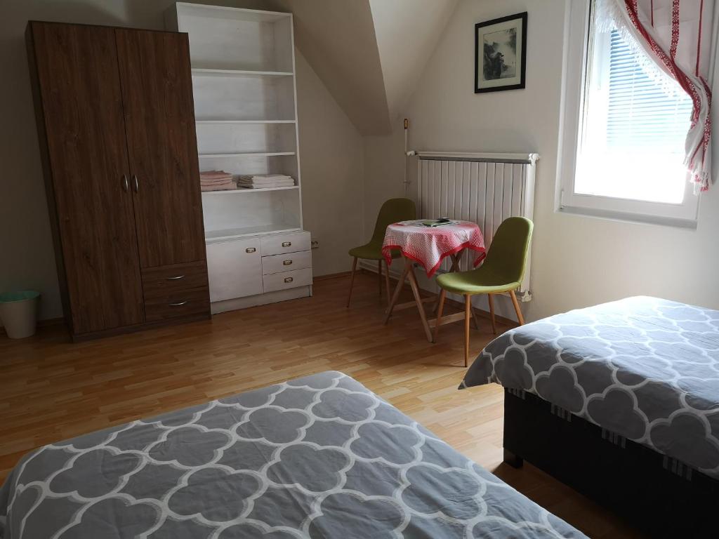a bedroom with a bed and a table and chairs at Family room for 4-6 person in Budapest