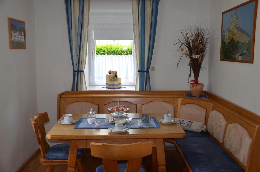 comedor con mesa, sillas y ventana en Ferienhaus am Jakobsweg, en Artstetten