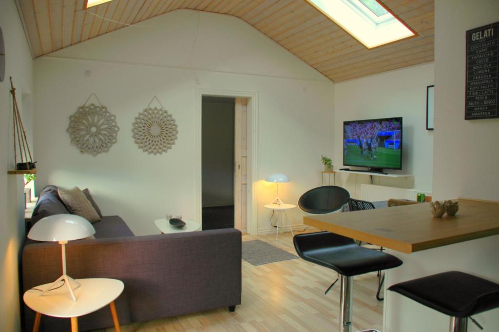 a living room with a couch and a table at Bakkely GuestHouse in Randers