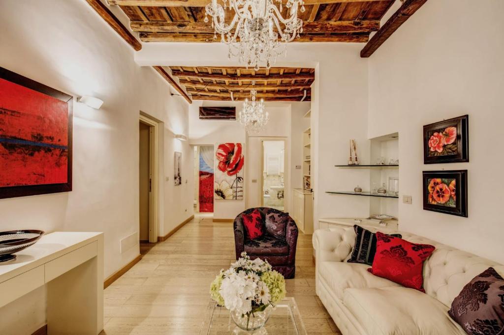 a living room with a couch and a chandelier at Portico D'ottavia in Rome