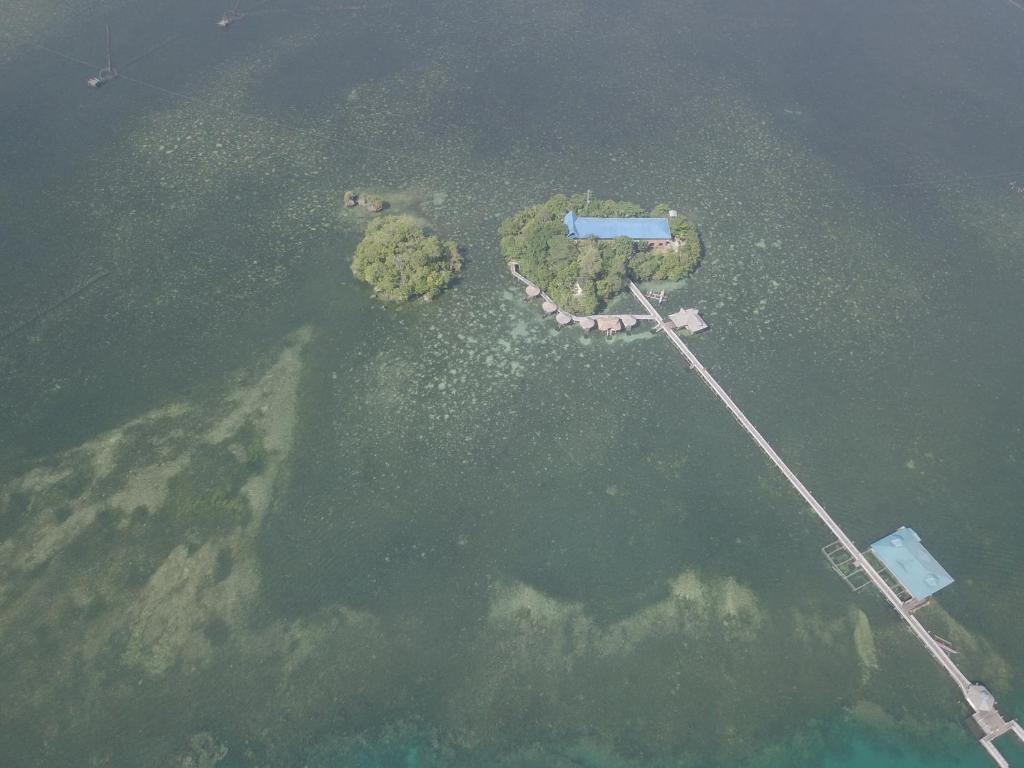 an aerial view of an island in the water at Enchanted River Rock Island Resort in Hinatuan