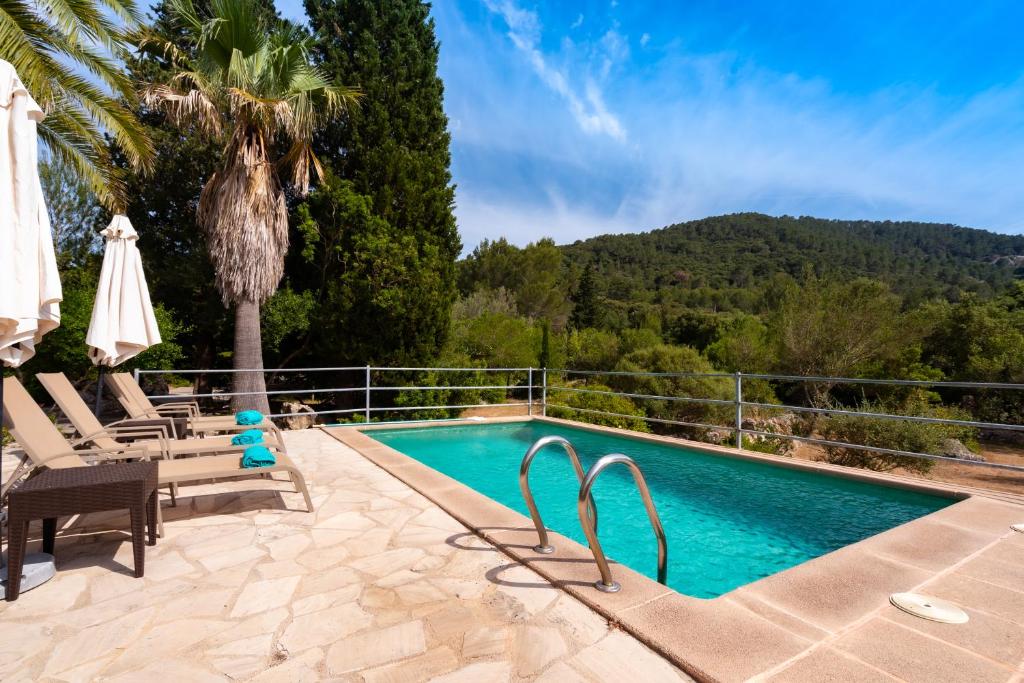 a swimming pool with a view of a mountain at Can Company in Campanet