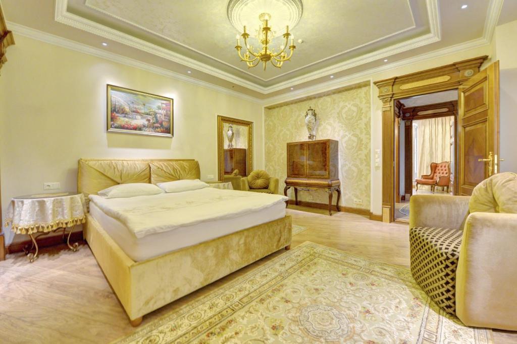 a bedroom with a king sized bed and a piano at Luxury Pilies Avenue Apartment in Vilnius