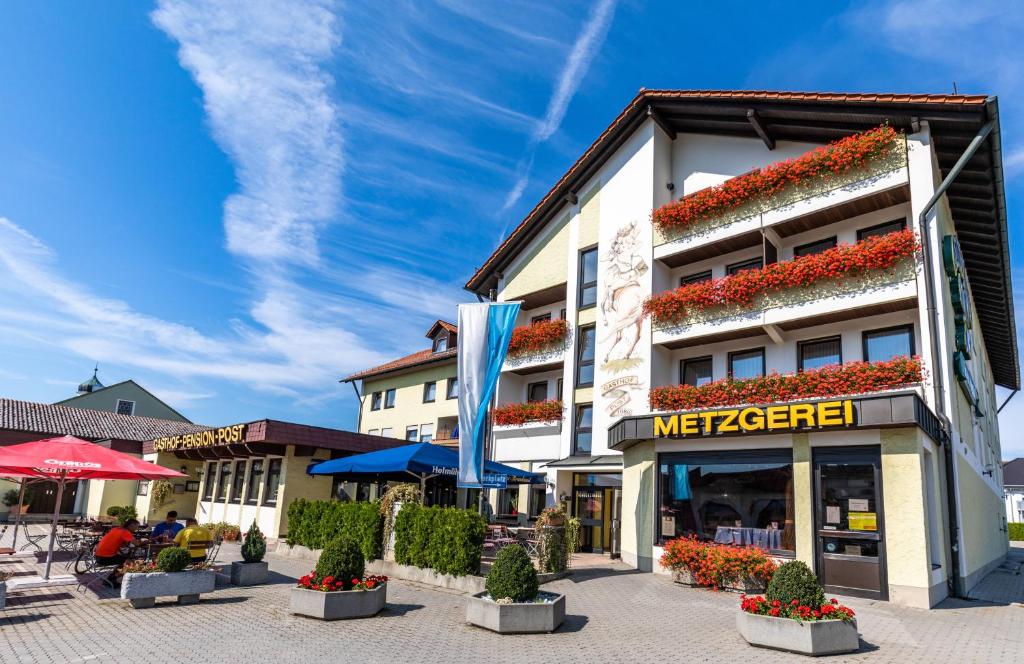 a building with a meezer sign on the side of it at Gasthof Pension Post in Denkendorf