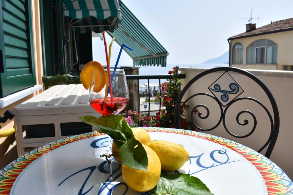 a table with a glass of red wine and some lemons at LA CASA DI ZEFFIRO in Maiori