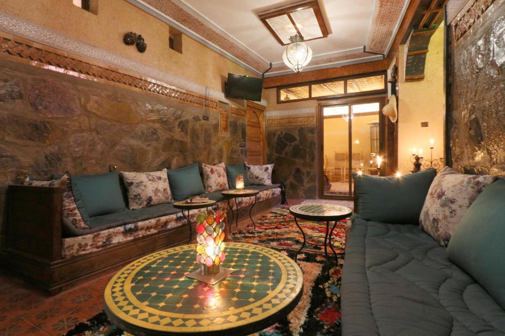 a living room with a couch and a table at Toubkal Garden in Imlil