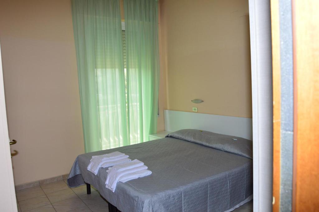 Postel nebo postele na pokoji v ubytování Hotel Perla
