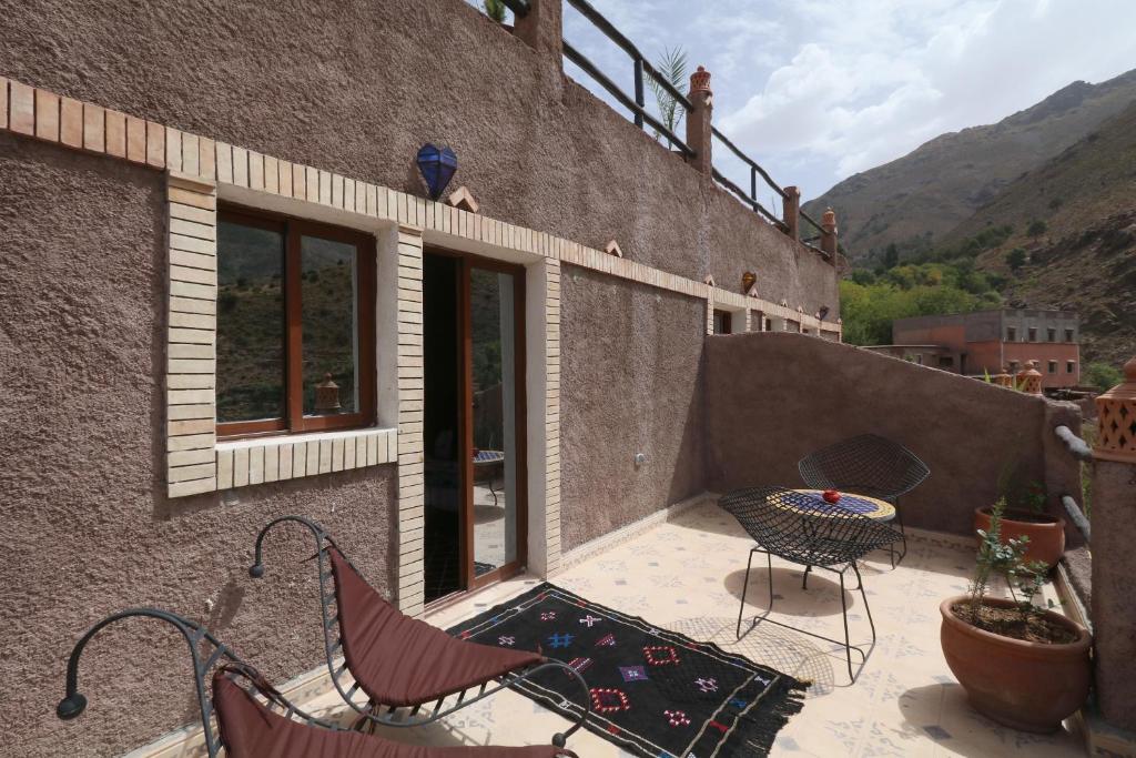 a patio with chairs and a table on a building at Toubkal Garden in Imlil