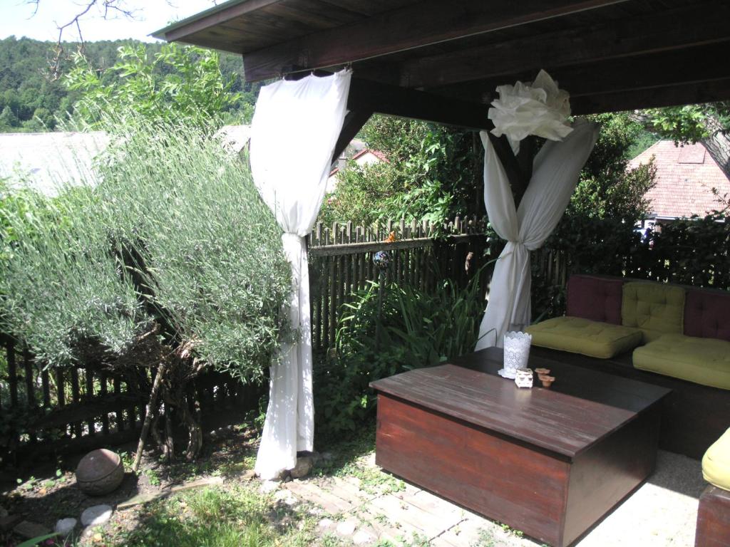 a gazebo with a table and a white curtain at Apartment 43 in Oberhöflein