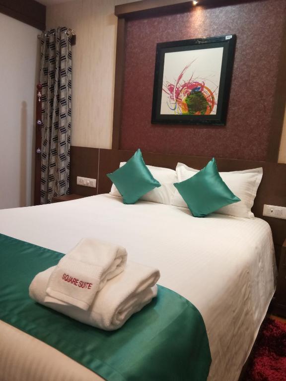 Postel nebo postele na pokoji v ubytování Square Suite