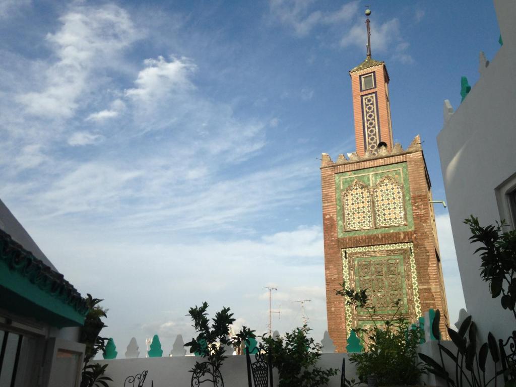 une grande tour avec une horloge en haut dans l'établissement Dar Nakhla Naciria, à Tanger