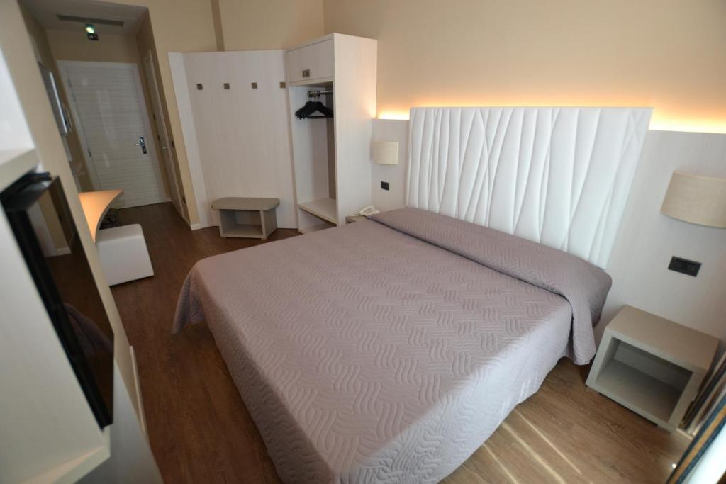 Posteľ alebo postele v izbe v ubytovaní Hotel Enrichetta