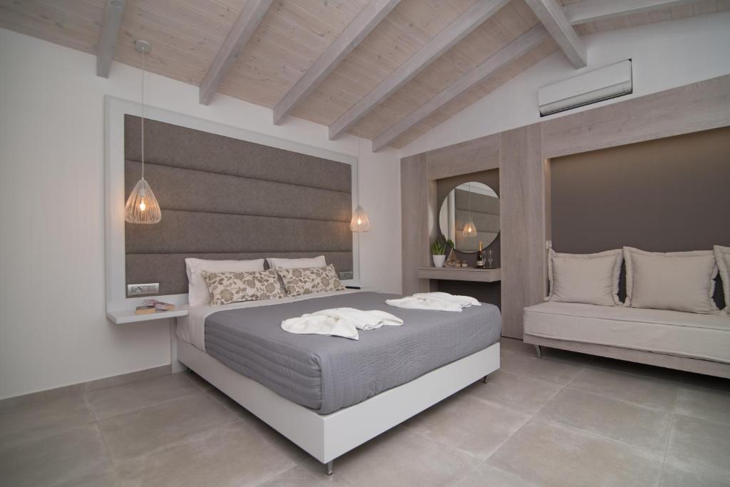 
a hotel room with a large bed and a large window at Dora Apartments in Agia Pelagia
