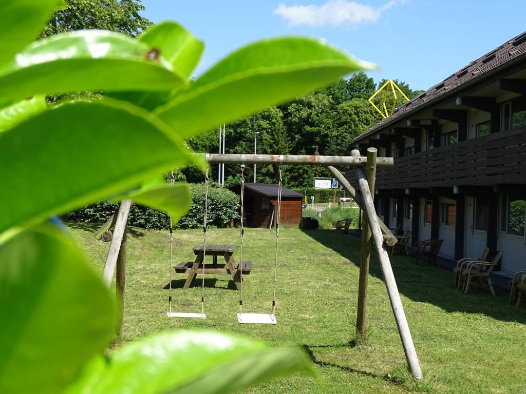 a swing set in the yard of a house at Value Stay Bruges in Bruges