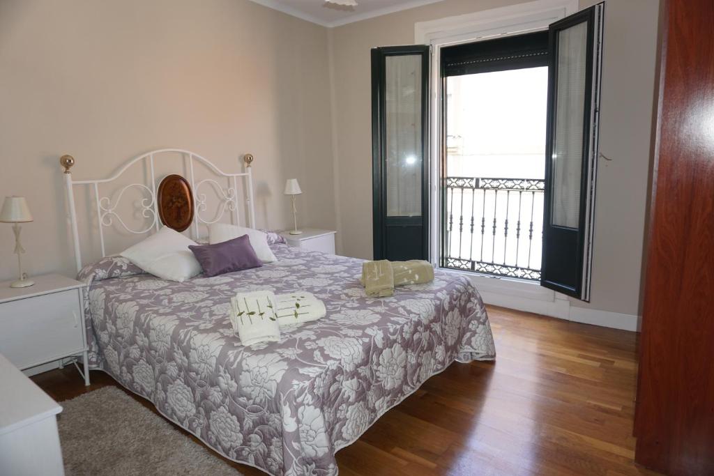 a bedroom with a bed and a large window at BELLA VIST EBI-1039 in Mundaka