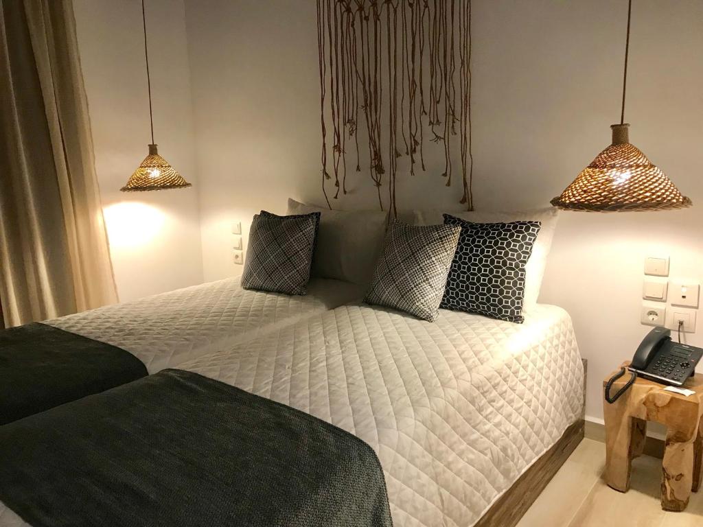 Postel nebo postele na pokoji v ubytování AELLIA HOTEL & SUITES LEROS