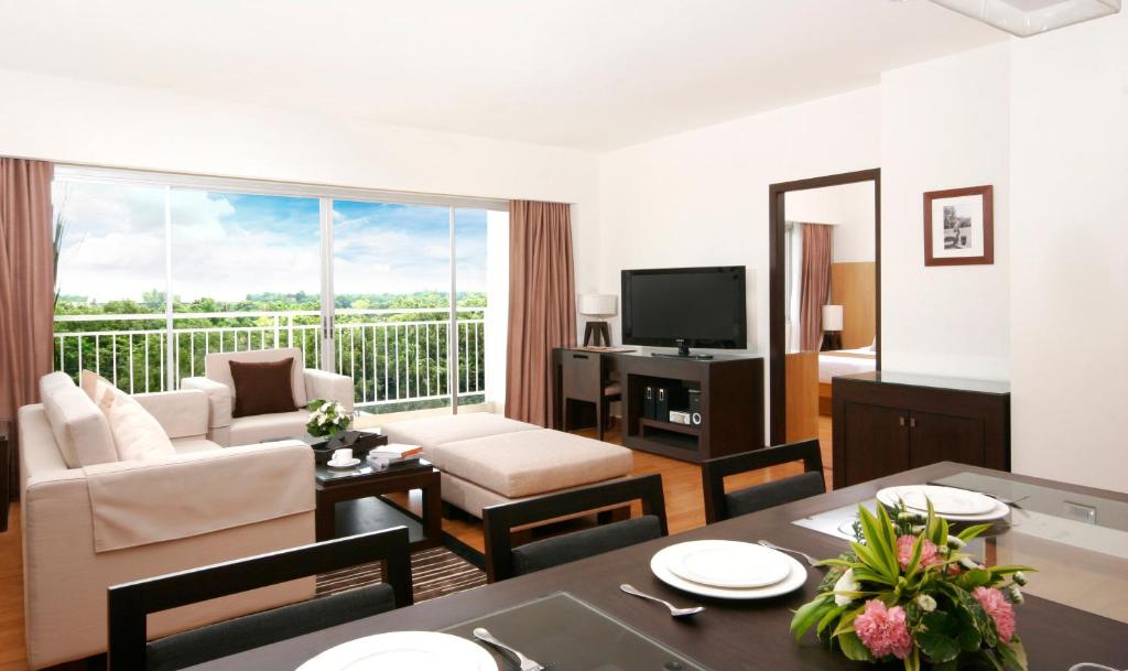 a living room filled with furniture and a tv at Kantary Hotel Kabinburi in Kabin Buri