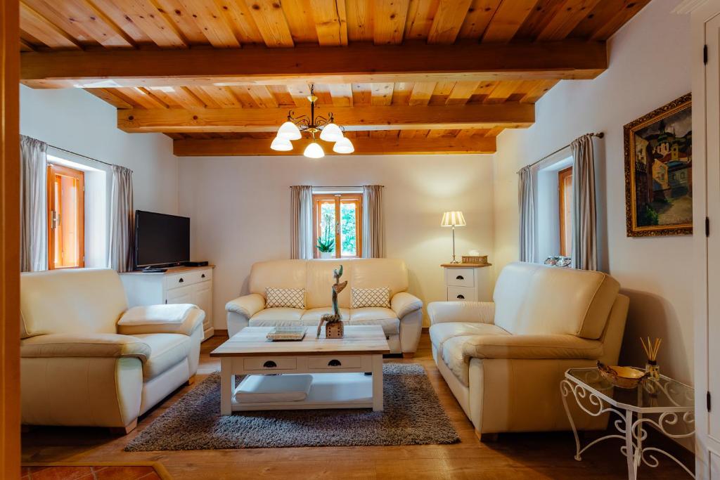 a living room with two couches and a coffee table at Stará mýtnica in Banská Štiavnica