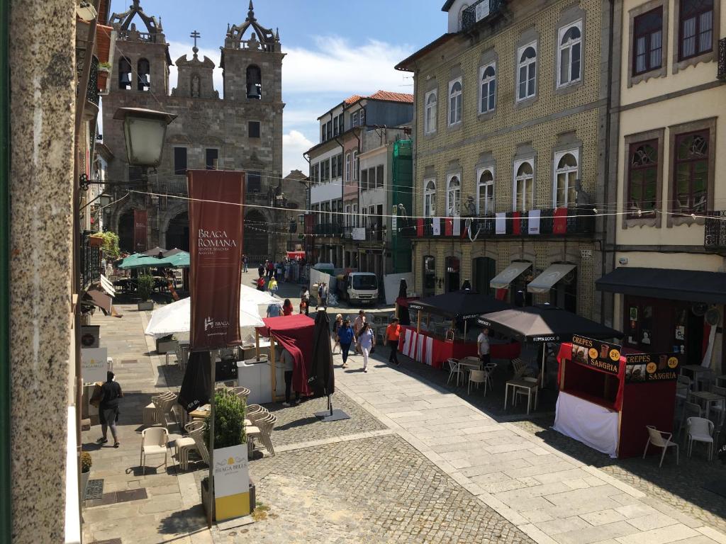 a city street filled with lots of shops and buildings at ÍSIS Guest House in Braga