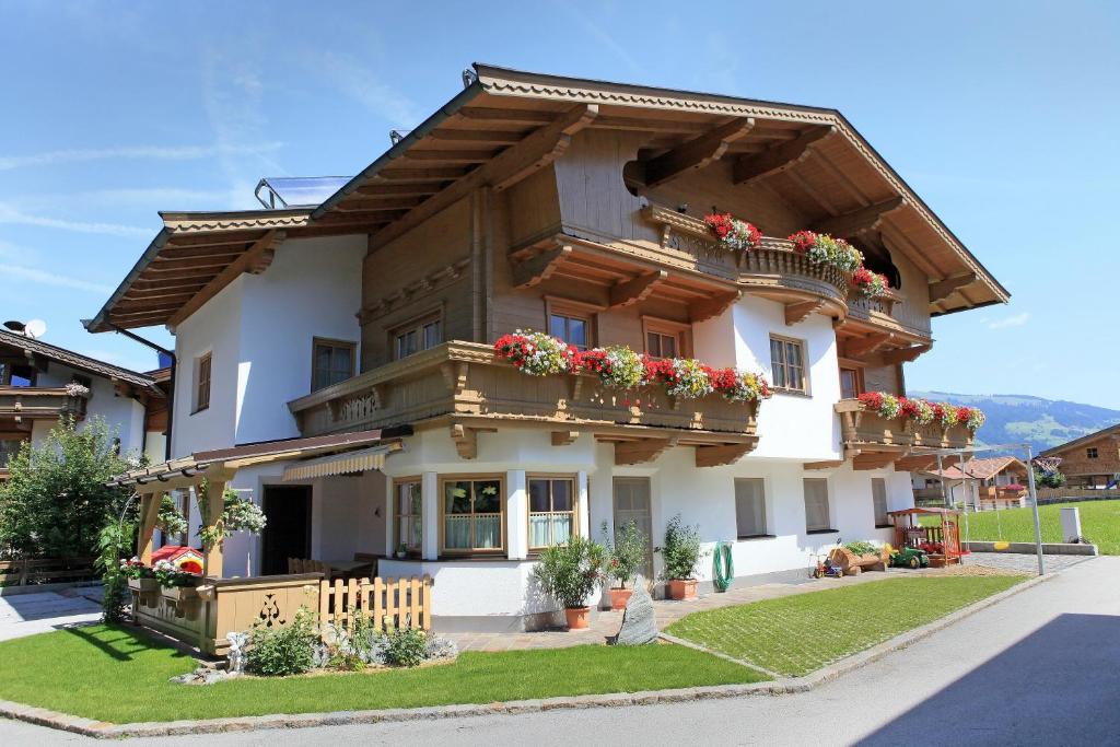 a large house with flowers on the balconies at Landhaus Aschaber in Westendorf