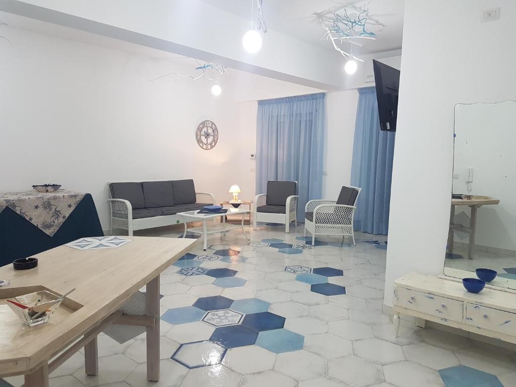 a living room with a blue and white floor at I colori del mare in Milazzo