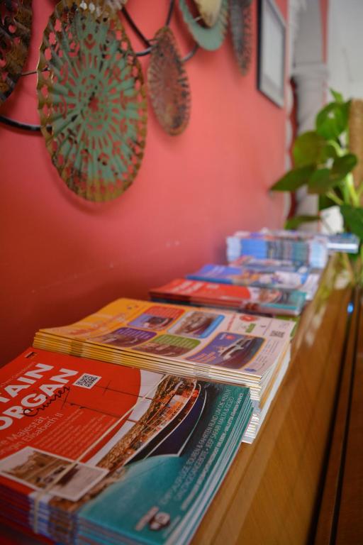 a counter with magazines and newspapers on a wall at Sensi Hotel in Marsaskala