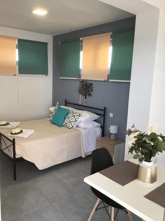 a bedroom with a bed and a desk and a table at Summer Studio - Zakynthos!! in Argassi