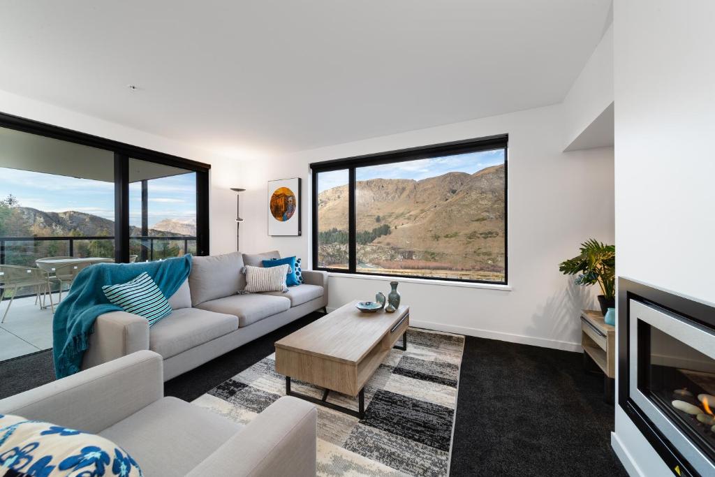 a living room with a couch and a table at Coronet Apartment, Complete comfort and views in Queenstown