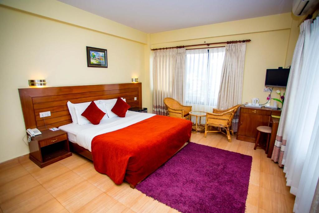 Ein Bett oder Betten in einem Zimmer der Unterkunft Hotel Tara