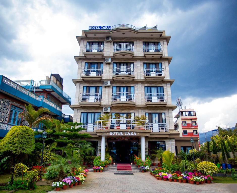 un edificio alto con flores delante en Hotel Tara, en Pokhara