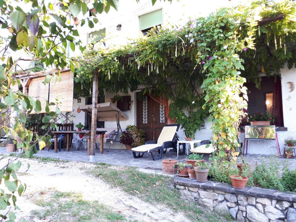 un patio de una casa con mesa y sillas en Villa Della Rocca, en Vobarno