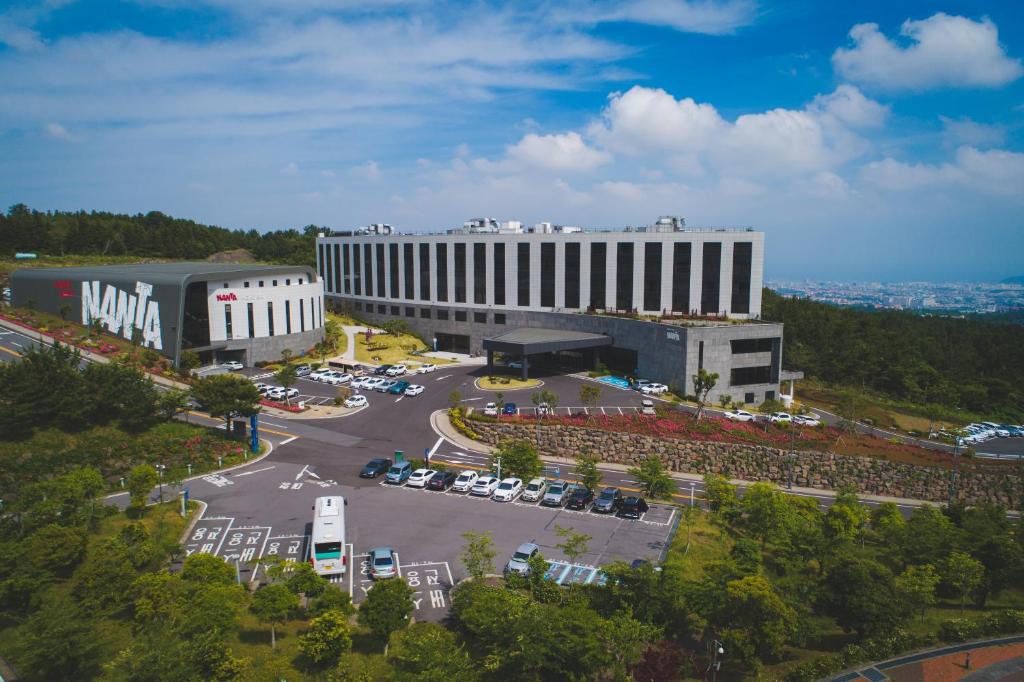 an aerial view of a building with a parking lot at Hotel Nanta Jeju in Jeju